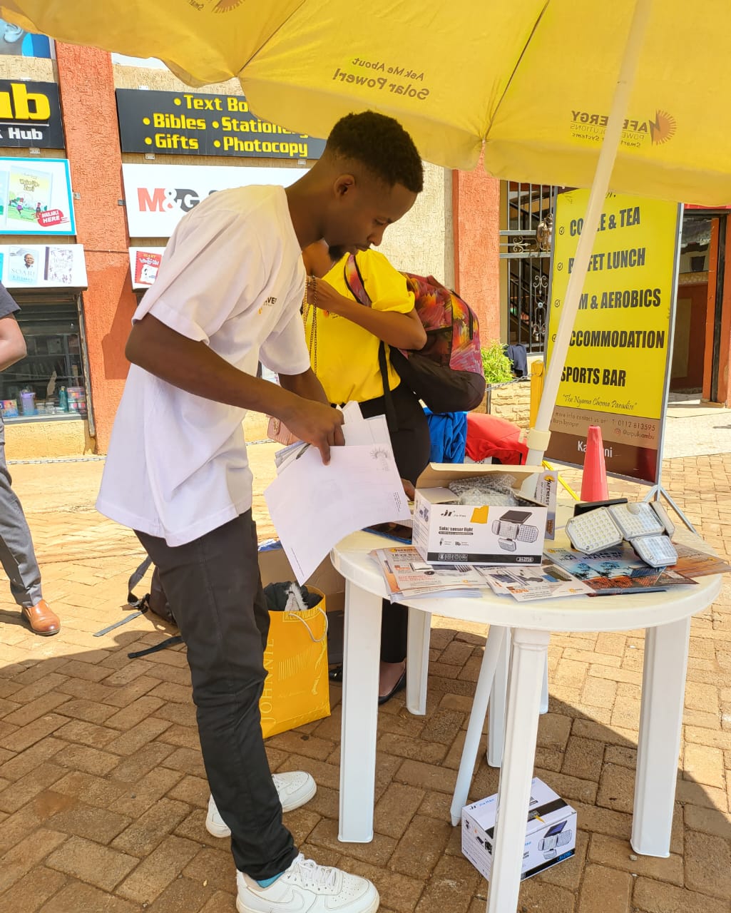AFENERGY agent unpacking a solar sensor light for a customer
