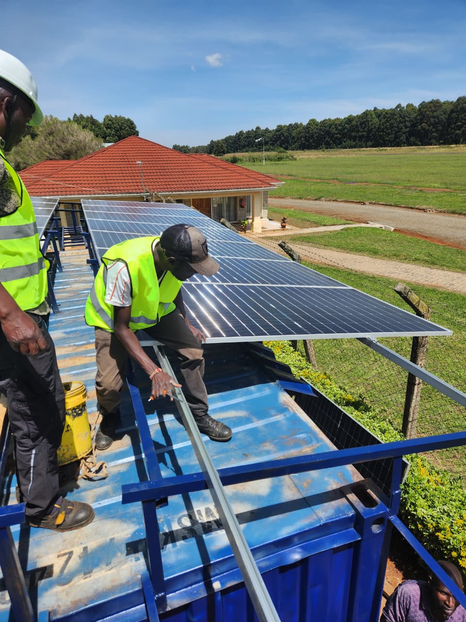 AFENERGY crew mounting solar modules on a rooftop rail system
