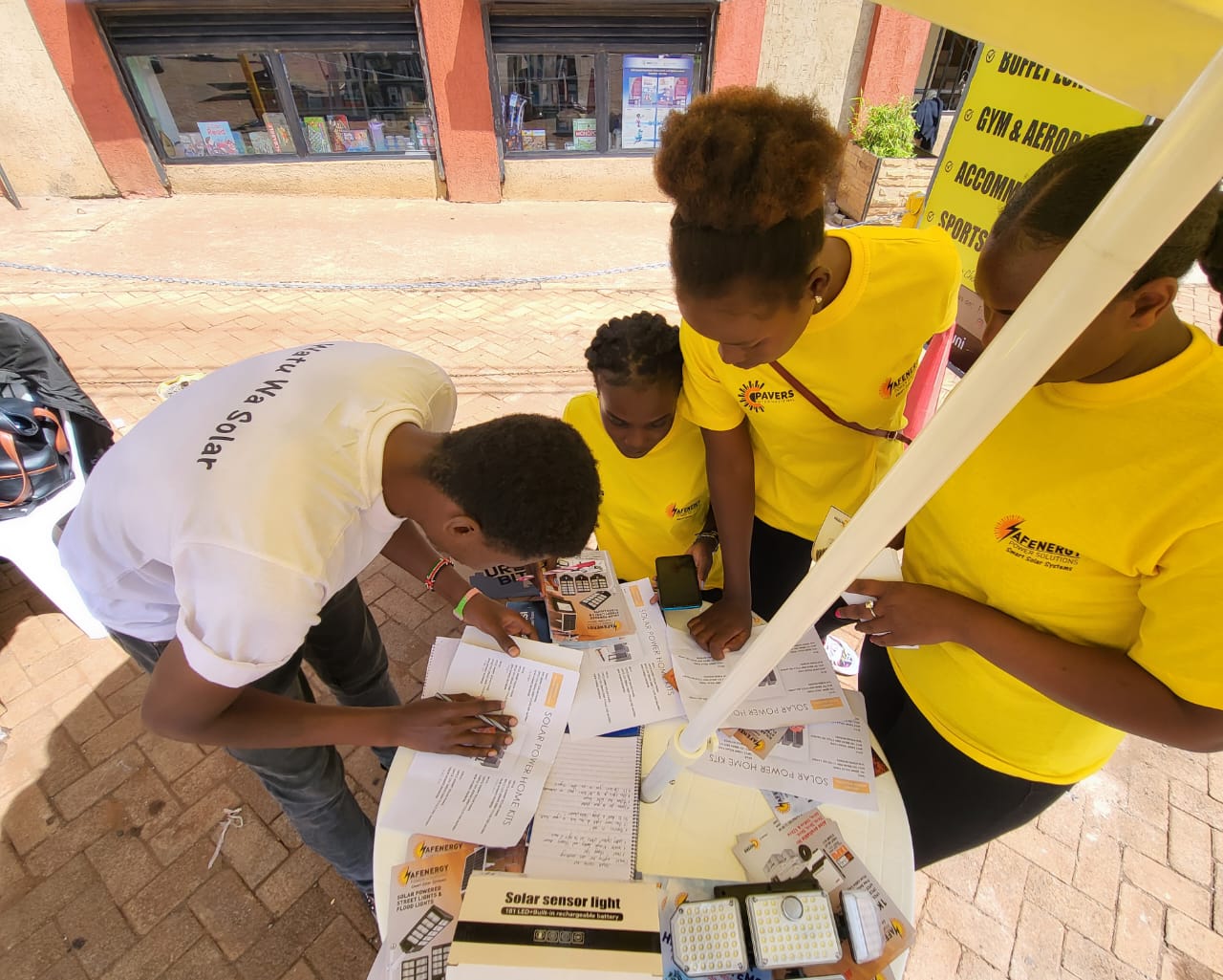 AFENERGY agents registering a customer for a solar home kit