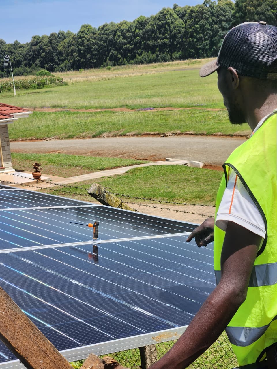 AFENERGY technician checking module spacing on a rooftop installation