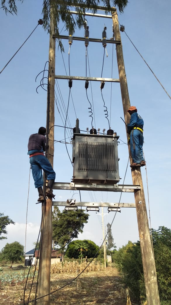 AFENERGY linemen commissioning a pole-mounted distribution transformer