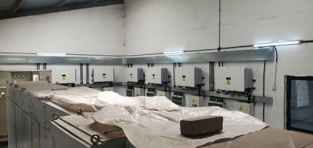 Bank of grid-tie solar inverters and isolators installed in a commercial plant room by AFENERGY, Nairobi