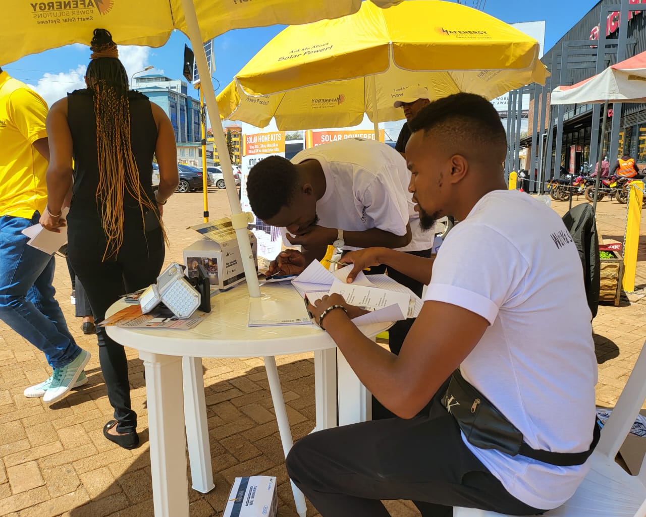 AFENERGY agents completing customer sign-up forms at the activation table